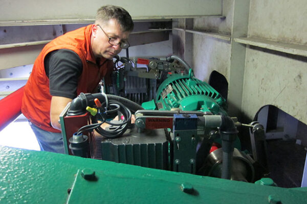 Technician working on an Electric AC Industrial Drum Brake System for a Lift Bridge