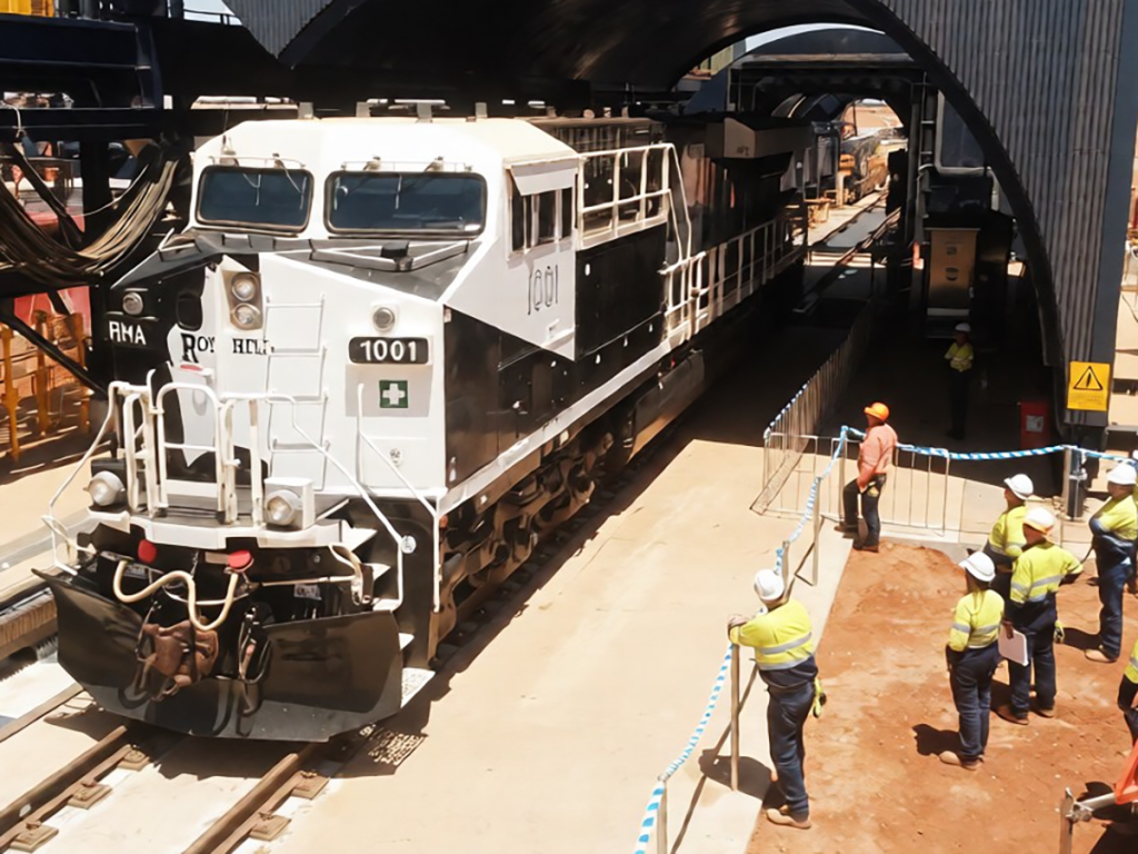 Locomotive in a rail maintenance depot with workers